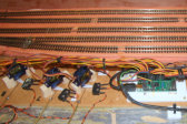 A close up of the Servo Motor Control Unit. Showing some of the servos and wire-in-tube links to the points. ( This photo was taken before any scenery was built.)